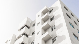 low-angle-shot-facade-white-modern-building-blue-clear-sky